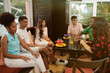 © etonastenka - Multiracial group of friends having a coffee together. Three women and three men at cafe talking laughing and enjoying their time