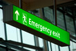 Green International Emergency Exit sign at the airport with pictogram