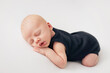 baby sleeping in black bodysuit
