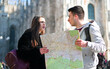 Couple of tourists in the city looking at a map and discussing about the next destination