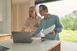 © Epic_pic - Front view of business couple on the kitchen with laptop and smartphone