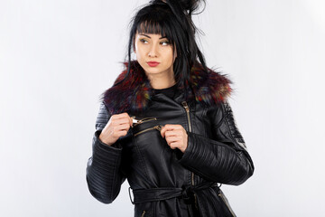 Wall Mural - Fashion model from Bosnia and Herzegovina in a leather jacket posing against a white background