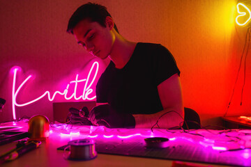 Wall Mural - Craftsman soldering wires of flex neon near tools 