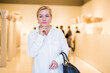 © JackF - Portrait of senior blonde woman visiting exposition at historical museum