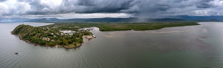 Wall Mural - Dramatic clouds in a panoramic aerial view over Port Douglas, Far North Queensland, Australia