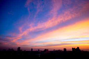 Wall Mural - Sunset sky with city in the shadow