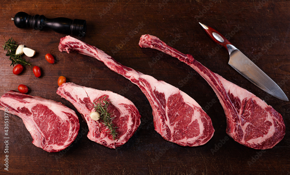 Tomahawk Rib Rack Tomahawk steak and Prime Rib on a large wooden cutting board top view ...