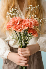 Wall Mural - Young woman with beautiful carnation flowers, closeup