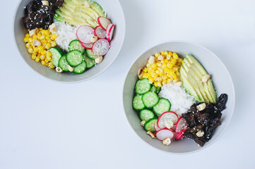 vegetarian buddha bowl with rice, avocado, corn, raddish and woody ear mushrooms. Healthy diet food