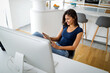 © NDABCREATIVITY - Beautiful young woman using laptop at home. Technology business education social network concept