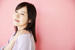 Beautiful asian woman on pink background