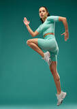 Sporty young woman jumping in the air