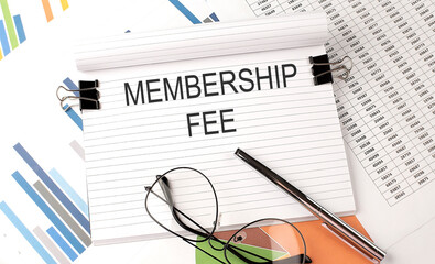 Poster - Notebook with text MEMBERSHIP FEE on table with charts,pen and glasses.