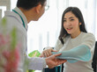 © Bangkok Click Studio - Doctor helping Asian patient with arm sling