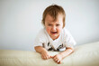 Baby crying at home, 2 years old, child's emotions, selective focus