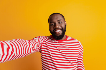 Wall Mural - Beautiful young man with a beard makes selfie toothy smile