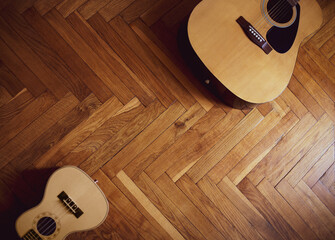 Sticker - Top view of a guitar and ukulele on the wooden floor with copy space