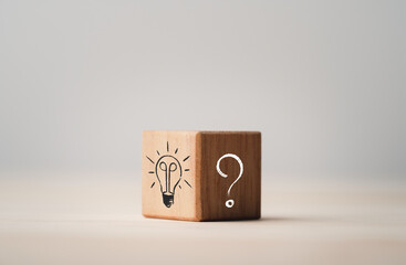 Fototapete - Drawing of light bulb on bright side and question mark on dark side of wooden cube block , problem solving and solution concept.