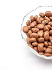 Sticker - Vertical shot of chocolate balls in a glass vase isolated on a white background