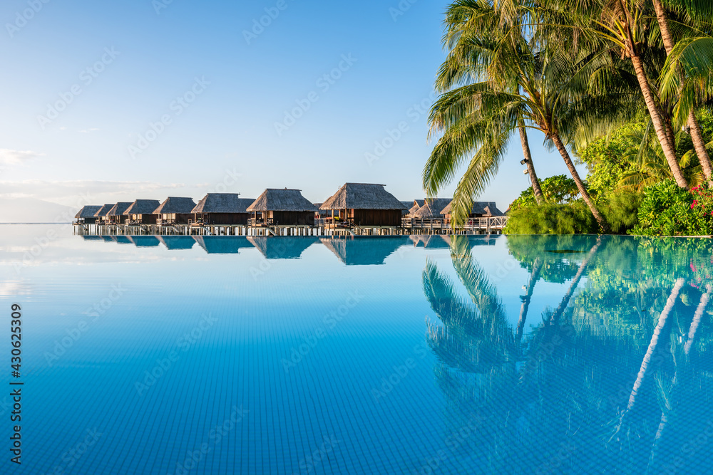 View of Infinity pool and overwater bungalows at a luxury beach resort Stock ...