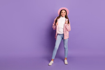 Sticker - Full length photo of attractive stylish girl wear pink hat jacket stand empty space isolated on purple color background