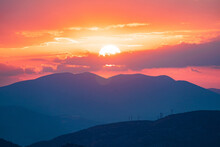 Orange Sky And Purple Mountains During A Sunset In Athens, Greece