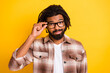 © deagreez - Photo portrait of brunet man touching glasses unsure having doubt wearing casual clothes isolated on vivid yellow color background