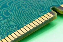 Close-up Gold Contacts Of Computer Memory Module On Green Background. RAM Memory Detail. Concept Electronic Design.  