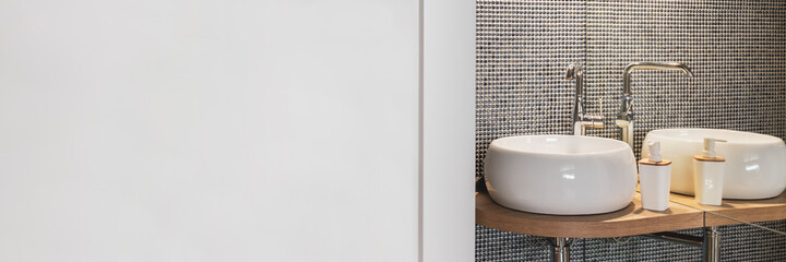 Empty wall in stylish bathroom interior with two sinks and lamps