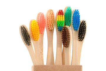 multicolored wooden toothbrushes on a white background, plastic rejection concept