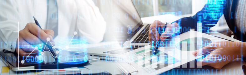 business people using tablets and using his finger to touch the screen with a business graph showing