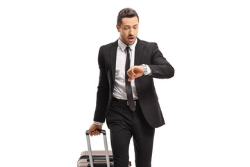 Sticker - Young businessman with a suitcase going on a business trip and looking at his watch