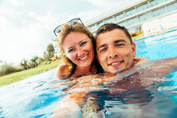 Couple relaxing in swimming pool