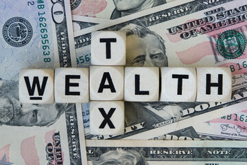 Wealth tx signage on a bed of American dollars.