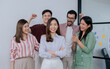 © Ann Rodchua - Group of mixed race people wearing casual business shirt, smiling with happiness and success, congrats and give applause to asian female leader.