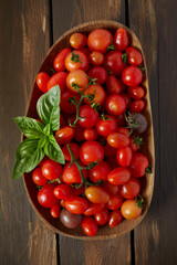 Sticker - variety of miniature tomatoes on dark wooden surface