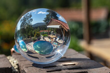 A Garden With A Terrace Reflecting In A Lensball