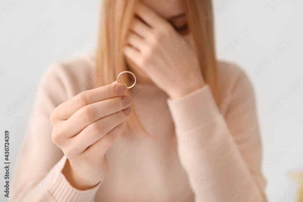 Woman with her wedding ring. Concept of divorce
