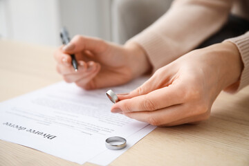 Wall Mural - Woman signing decree of divorce in lawyer's office, closeup