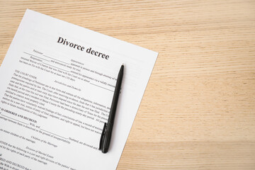 Wall Mural - Divorce decree with pen on wooden background