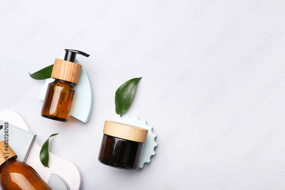 Bottles of cosmetics for hair on white background