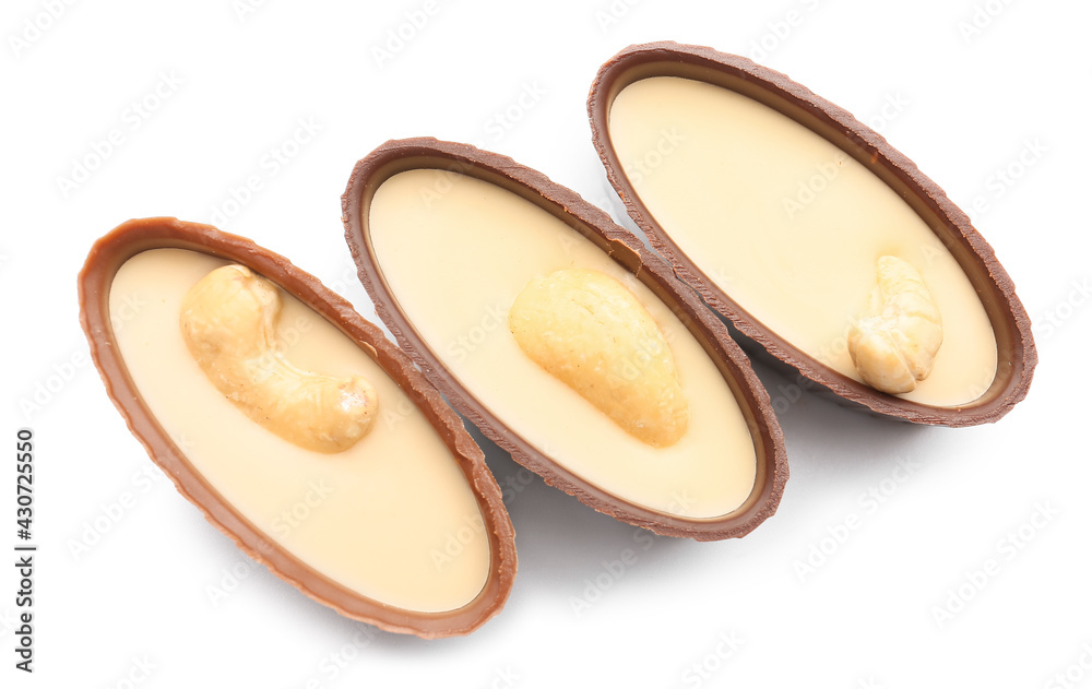 Tasty chocolate candies with nuts on white background