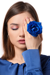 Poster - Beautiful young woman with blue rose on white background