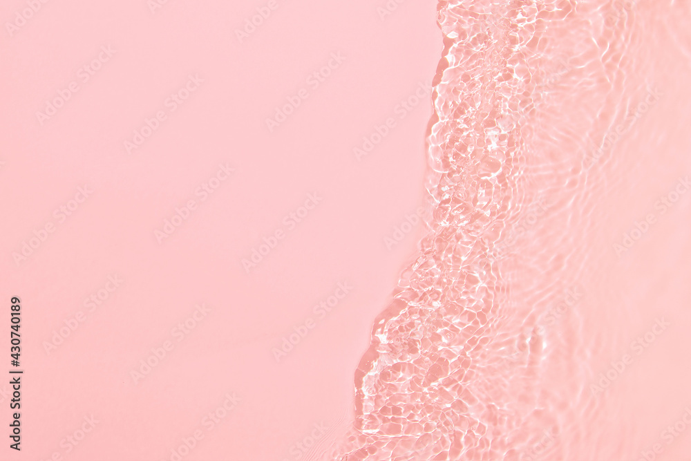 de-focused. Closeup of pink transparent clear calm water surface ...