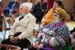 © Светлана Лазаренко - Elderly people in medical masks sit on chairs.