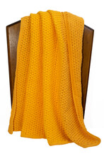 Yellow, Orange Crochet Blanket Arranged On A Chair, Isolated On White