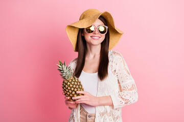 Wall Mural - Photo of pretty positive young girl arms hold pineapple have good mood isolated on pink color background