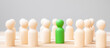 © Jo Panuwat D - Green leader business man with crowd of wooden people. leadership, business, team, teamwork and Human resource management concept