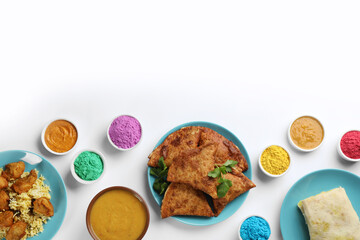 Flat lay of traditional Indian food and color powder dyes on light background, space for text. Holi festival