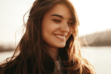 Happy woman with long hair enjoying sunset